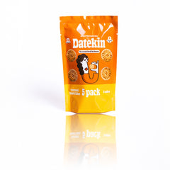 Orange packaging of Datekin caramel date cakes with a cartoon character and text on a white background