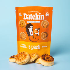 Orange packaging of Datekin caramel snack cakes with cakes on a light blue background